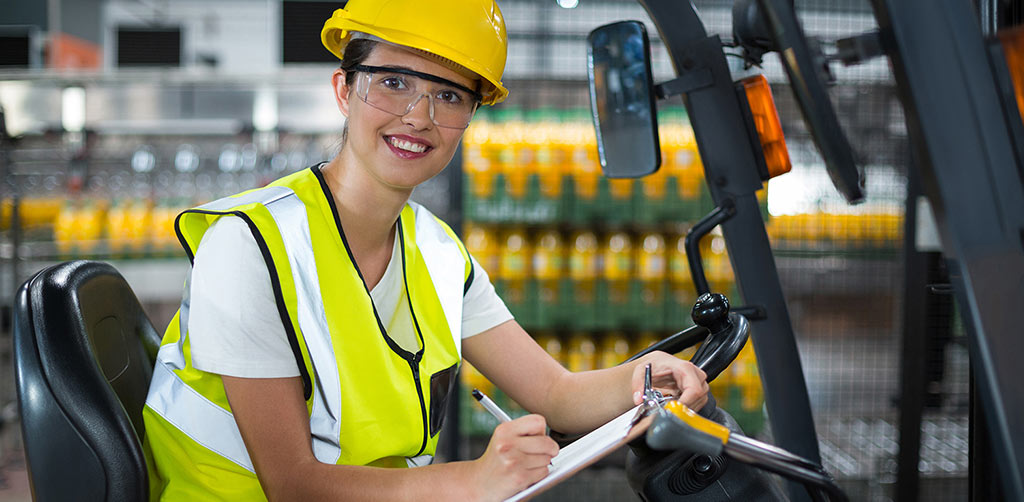 Female equipment operator in a hardhat